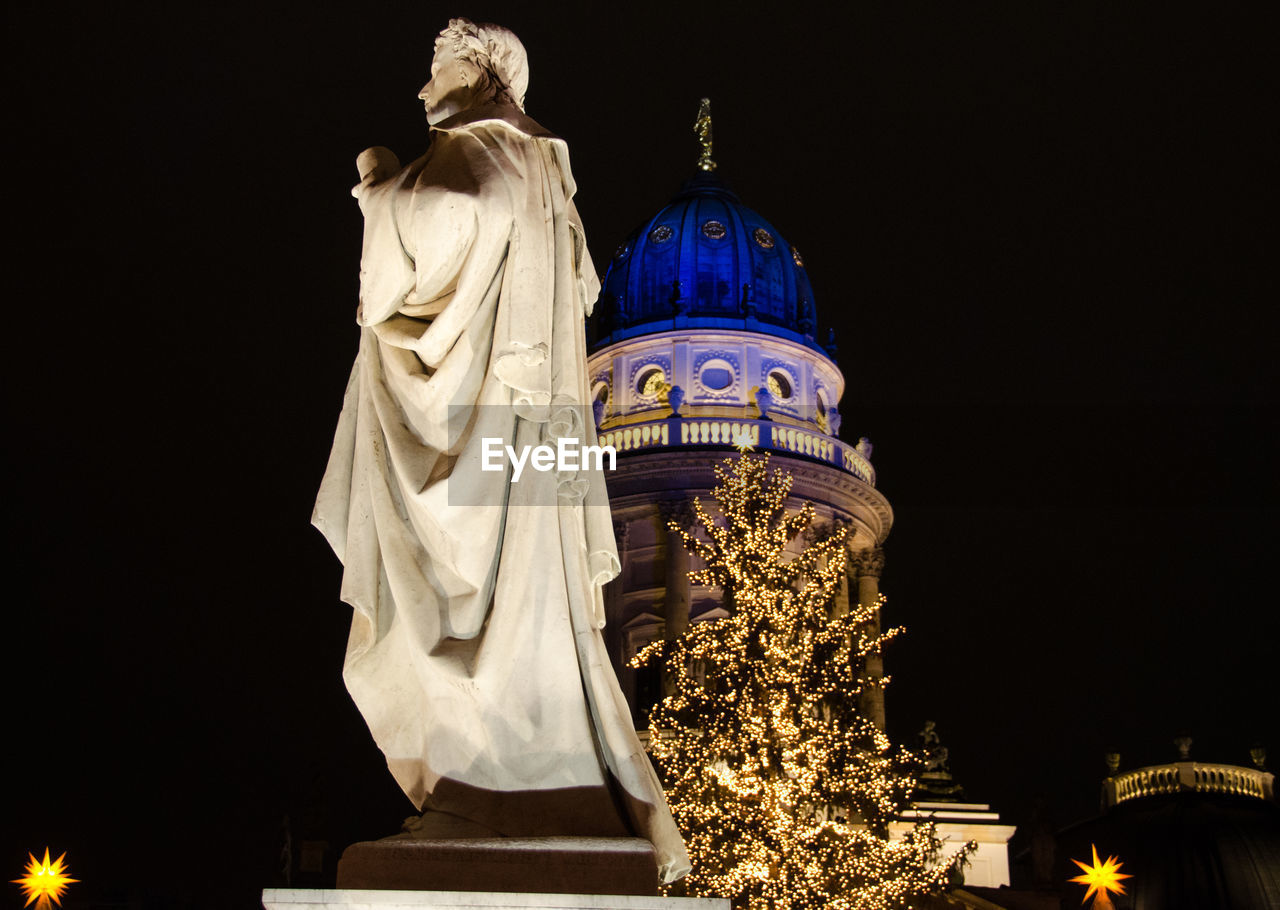 Low angle view of statue at night