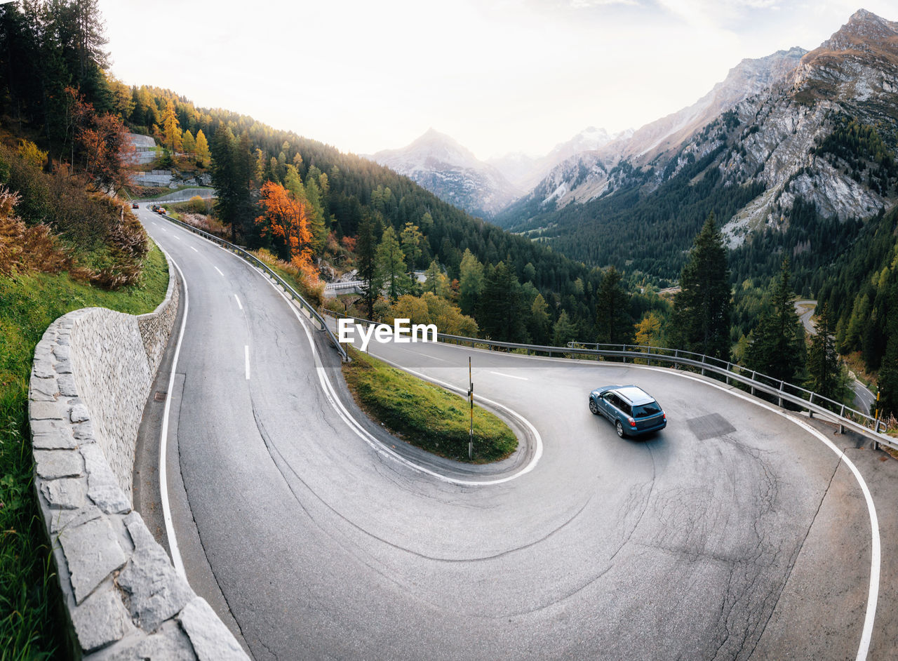 High angle view of car on winding road by mountains