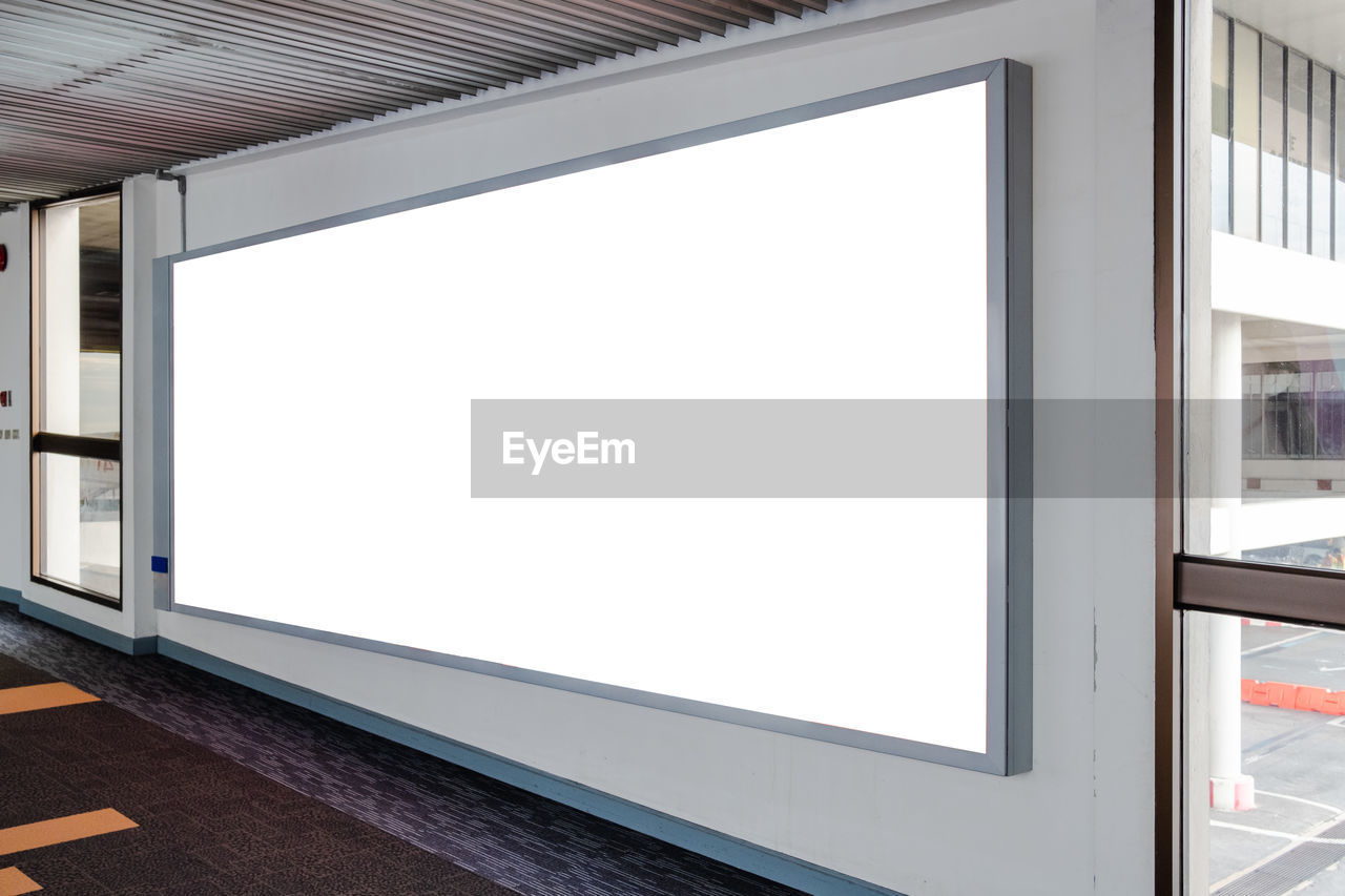 Blank advertising billboard in the airport walkway.