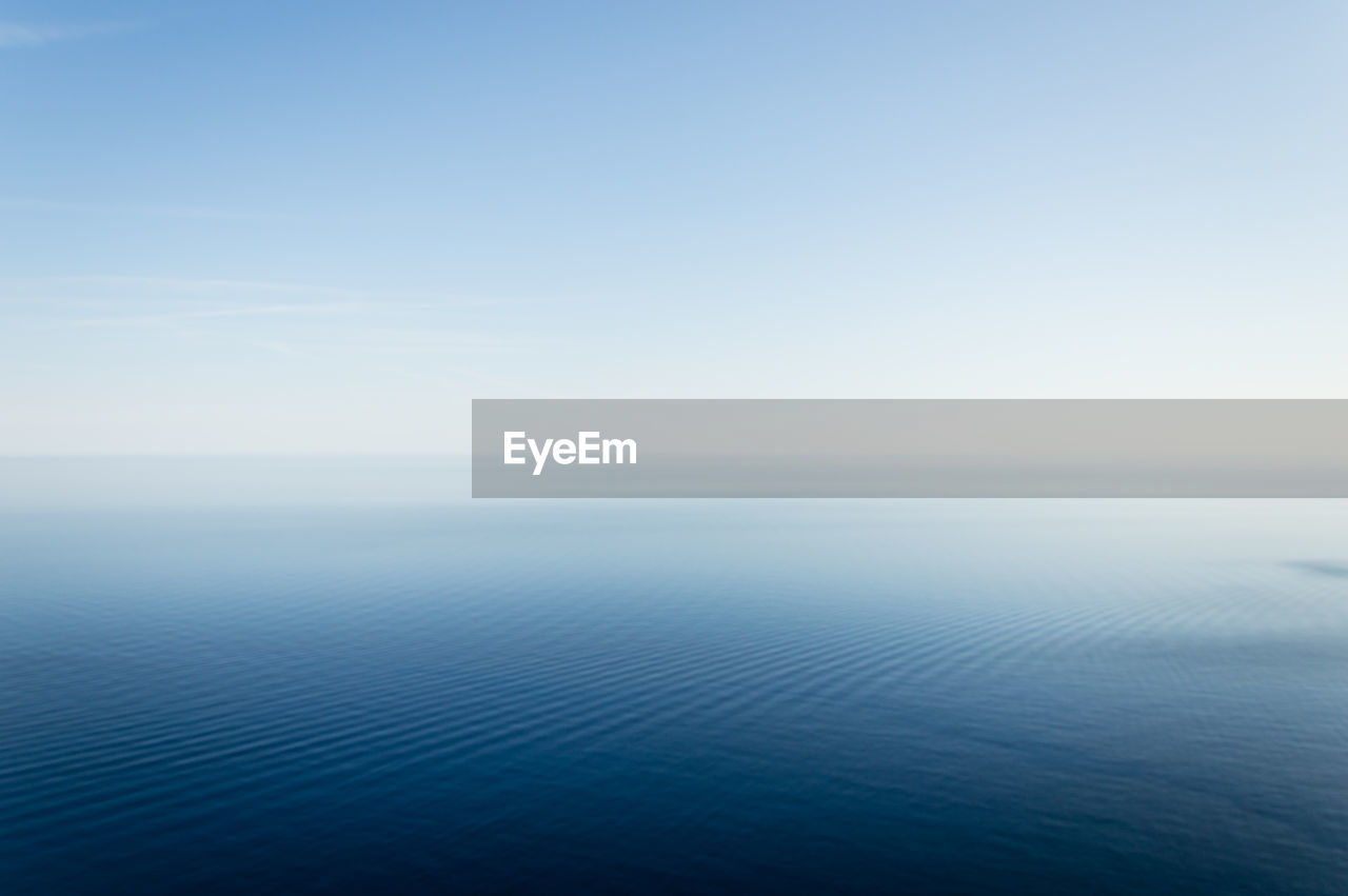 Scenic view of sea against blue sky