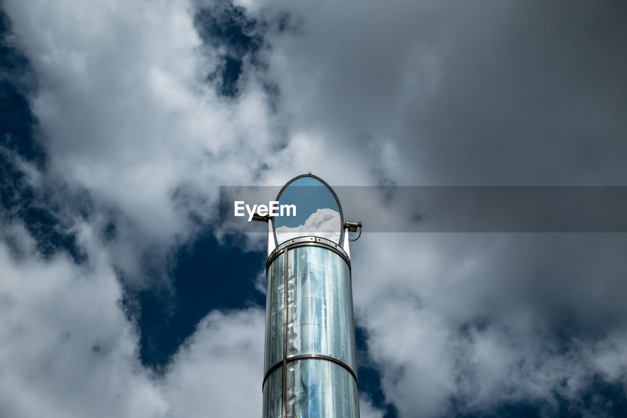 Low angle view of tower against cloudy sky