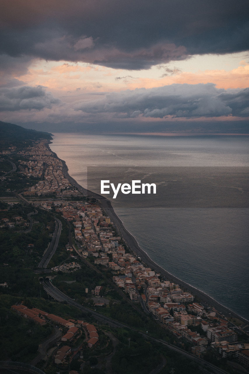 Aerial view of sea against sky during sunset