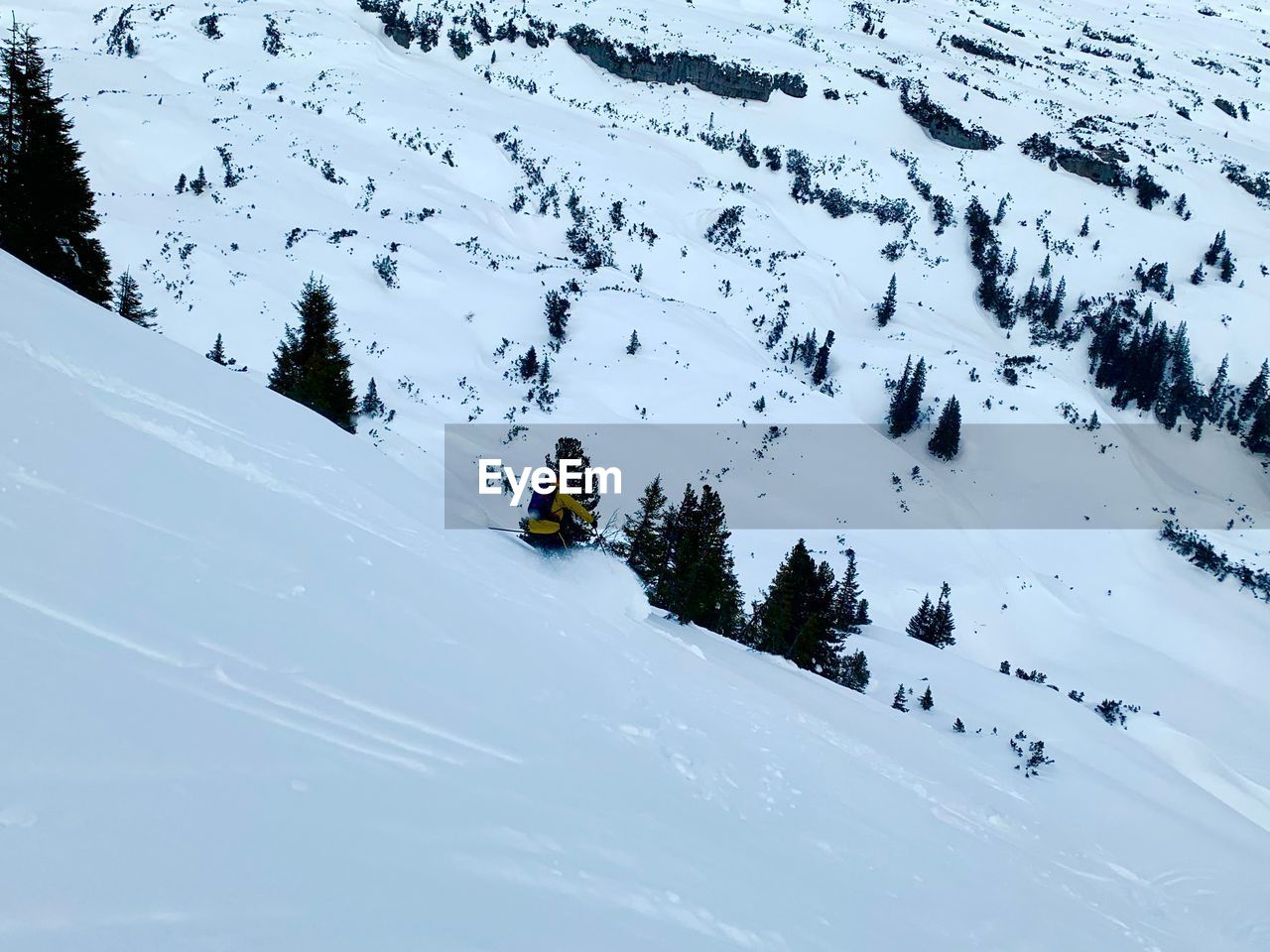 High angle view of man skiing on snow covered land