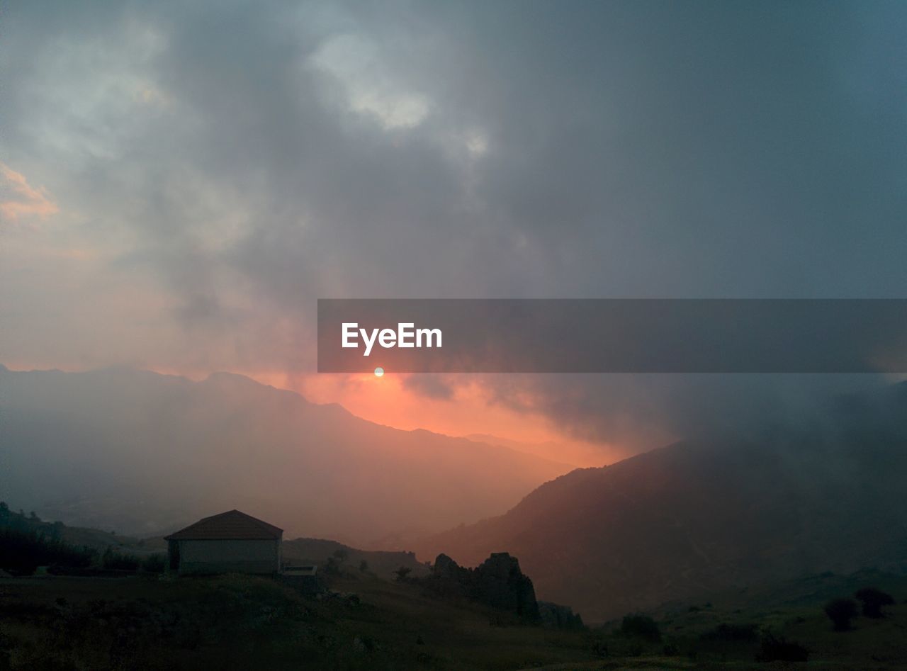 SCENIC VIEW OF MOUNTAINS DURING SUNSET