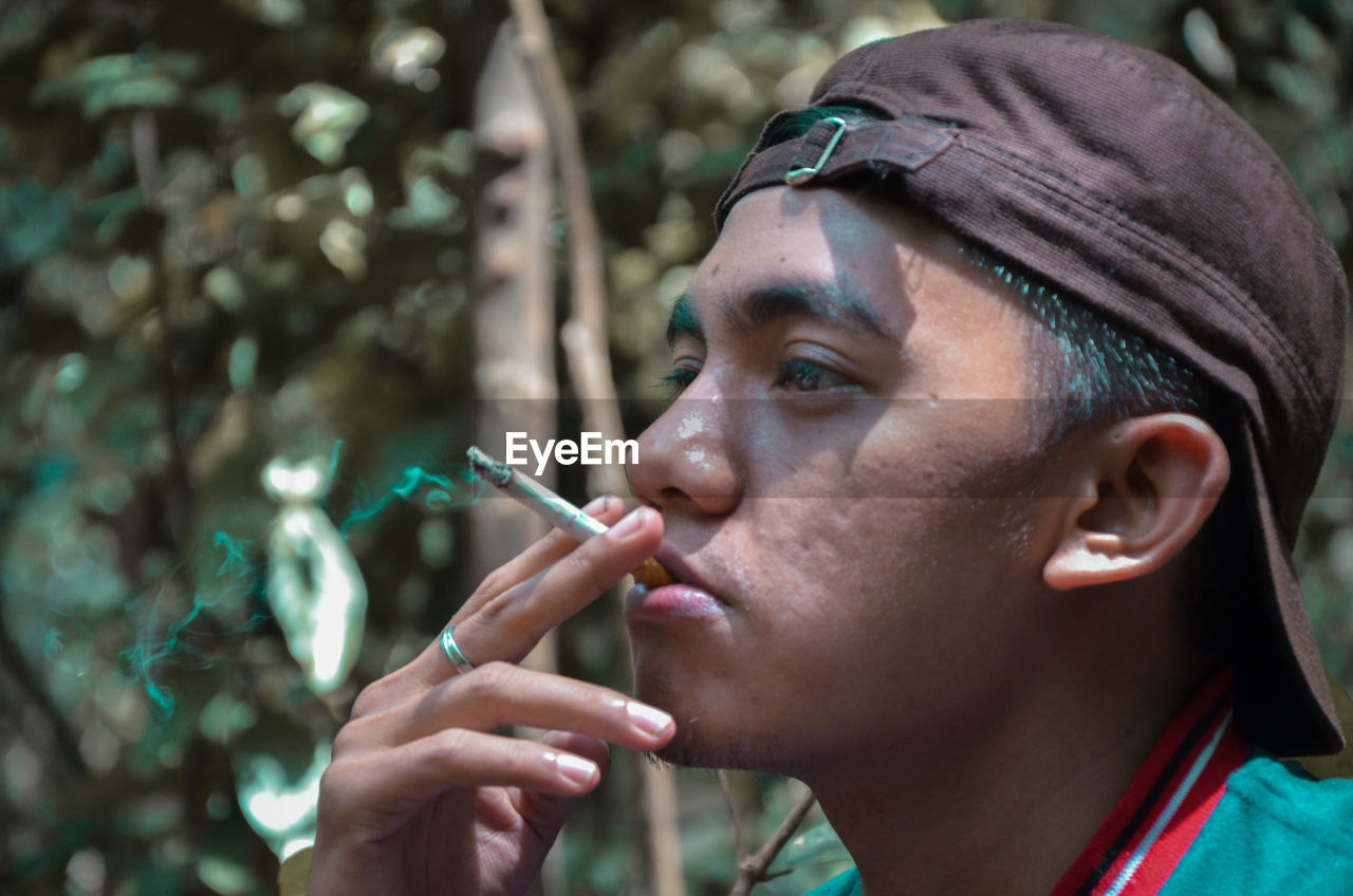 Close-up of man smoking cigarette