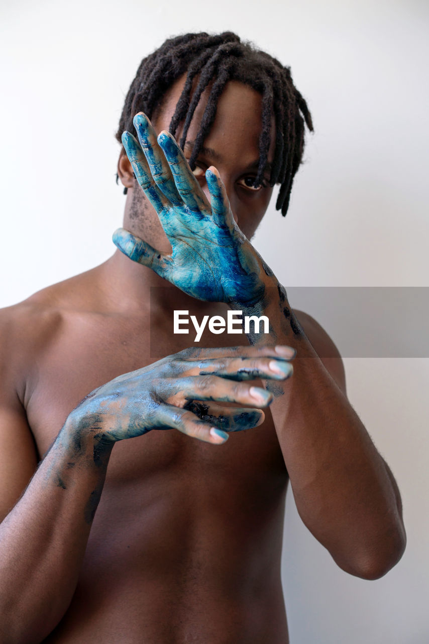 Artistic black man with painted hands