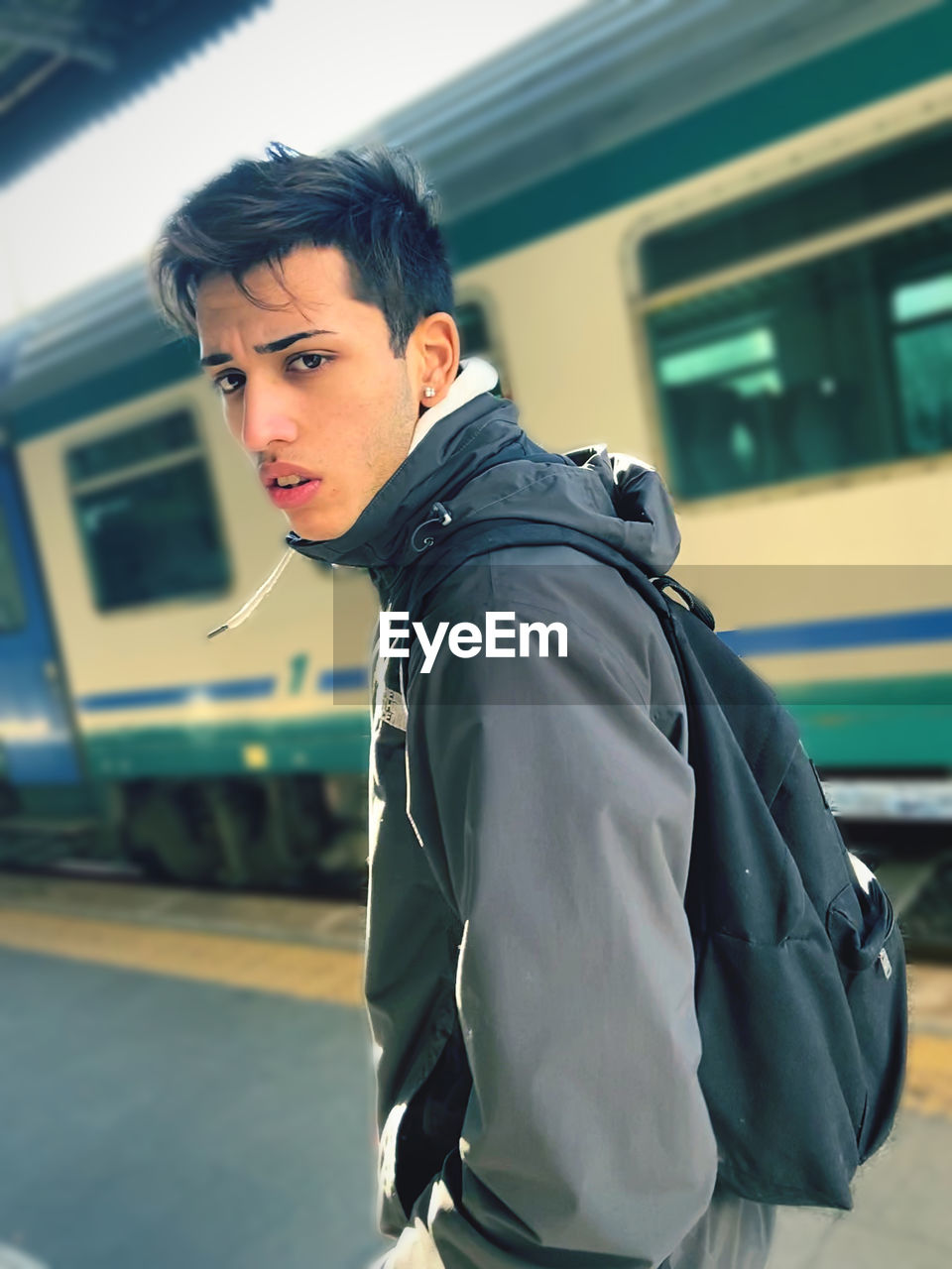 Portrait of teenage boy standing at railroad station
