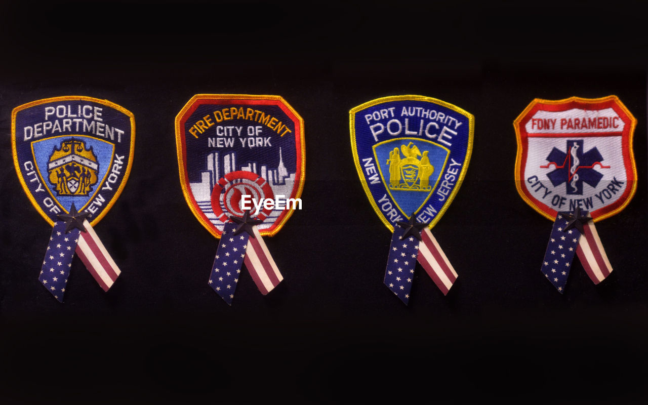 Close-up of badges against black background