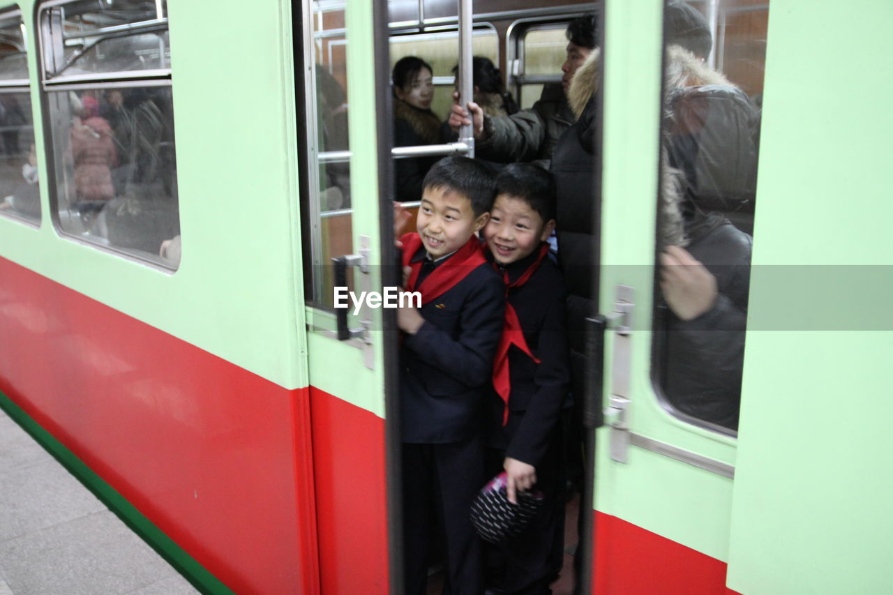 PEOPLE WAITING AT TRAIN AT SUBWAY STATION