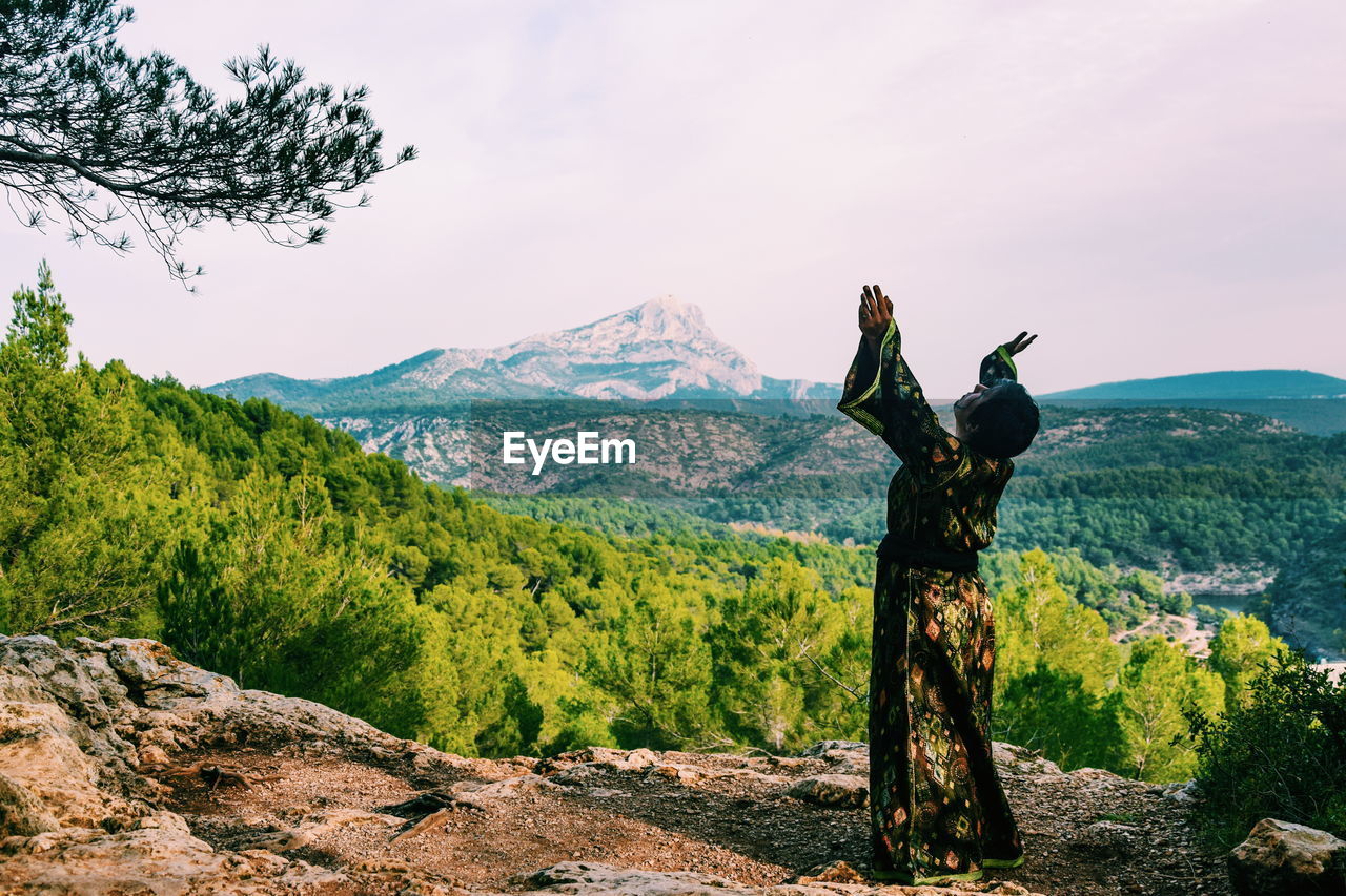 Mature woman wearing kimono while standing on mountain