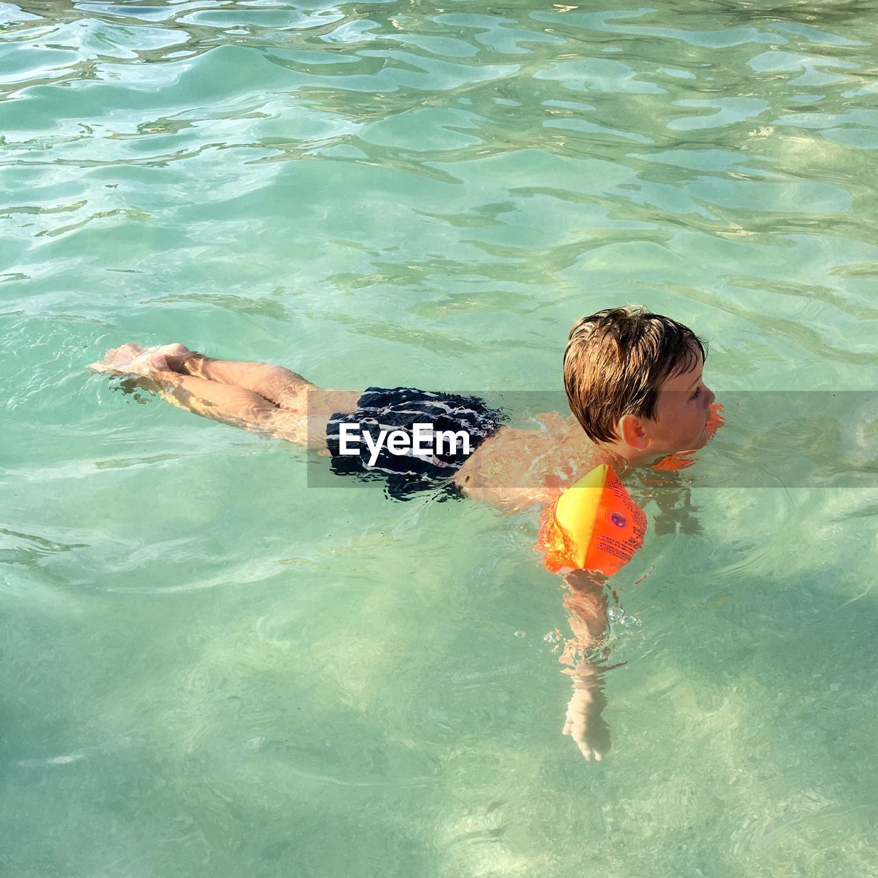 High angle view of boy swimming in pool