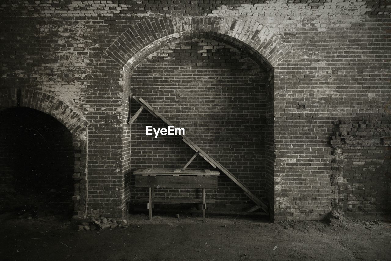 Table under arch of old brick wall