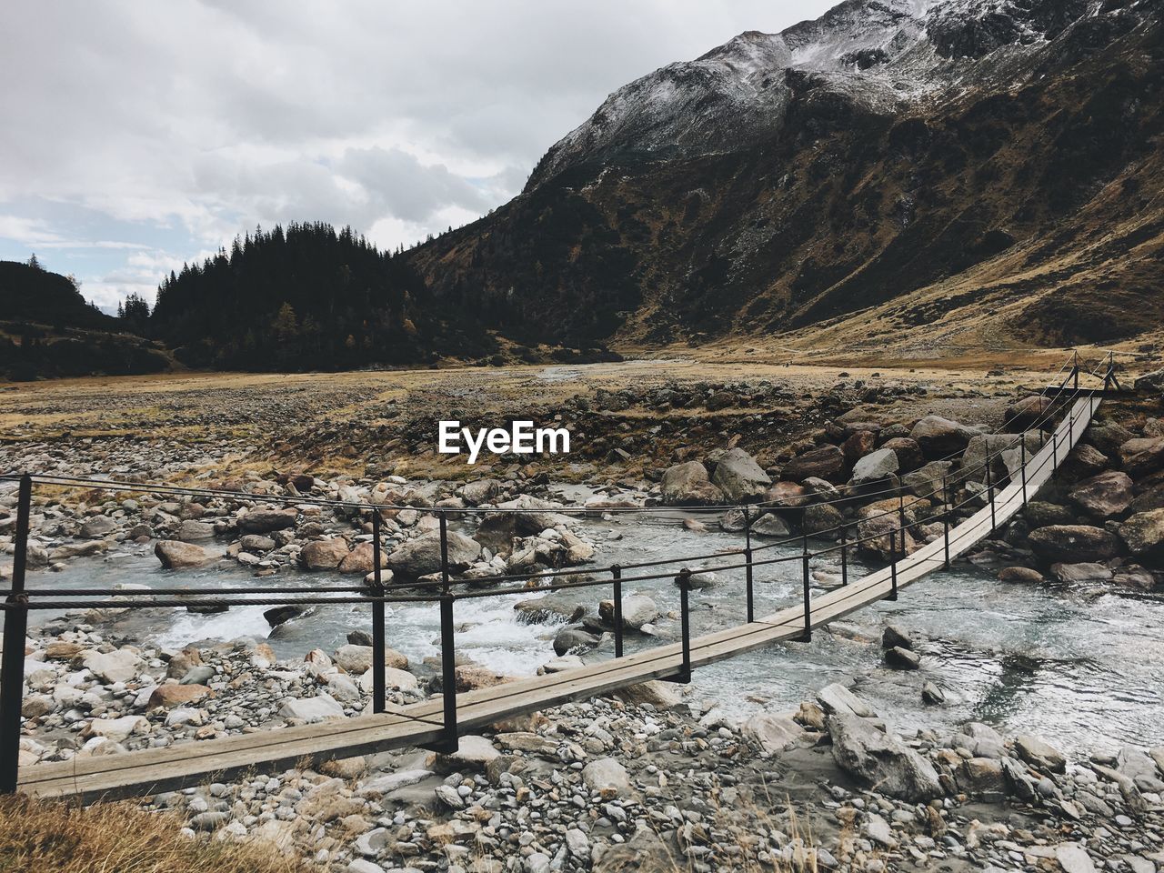 Scenic view of bridge over river and mountains