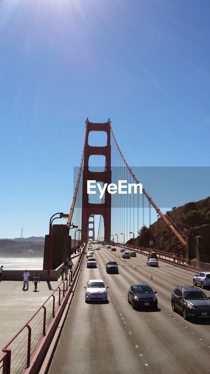 View of suspension bridge against blue sky