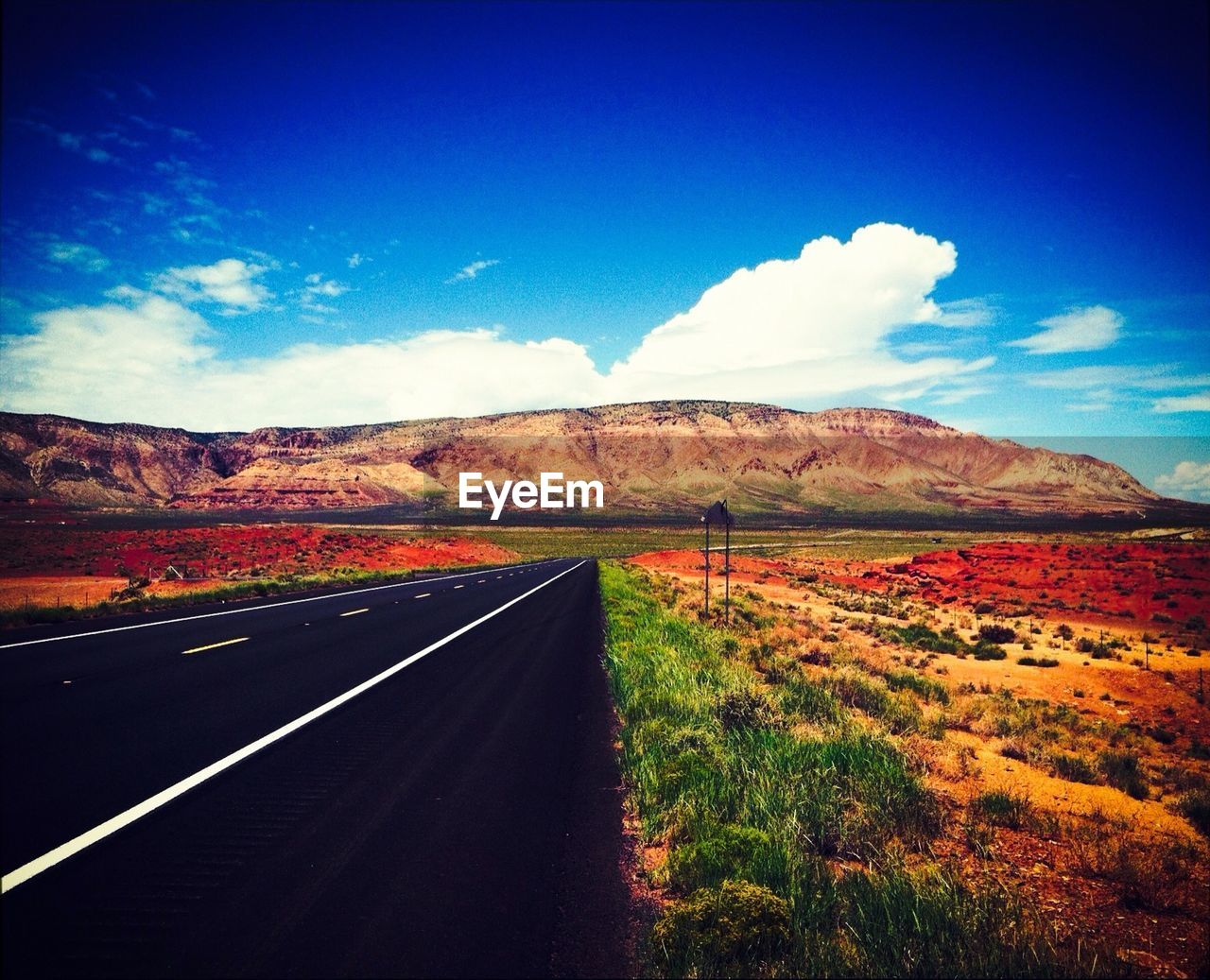 Empty road along countryside landscape