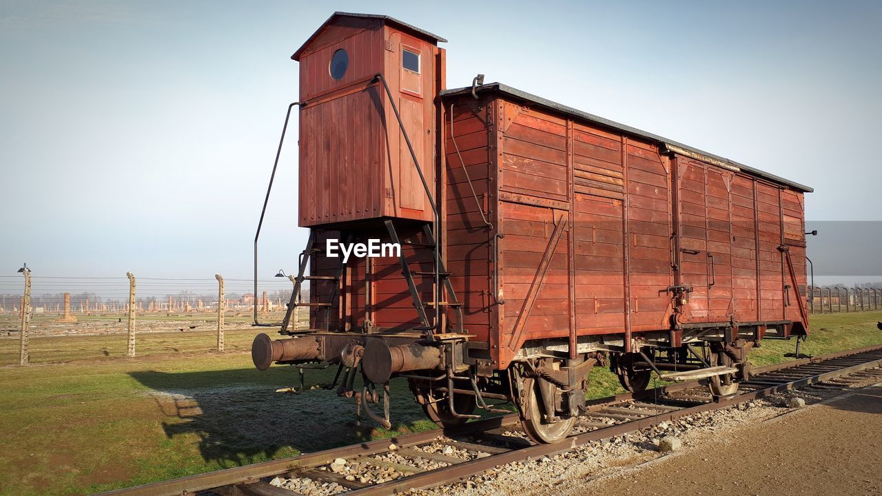 Train on railroad track against clear sky