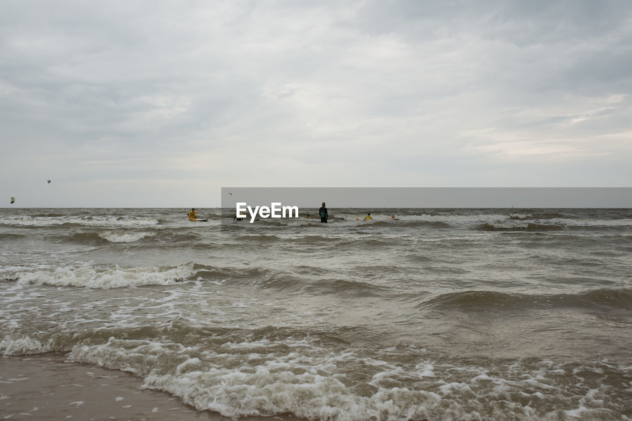 MAN STANDING IN SEA