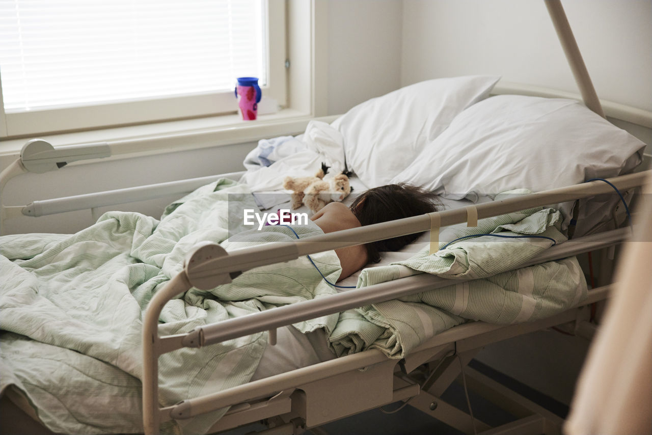 Child sleeping in hospital bed