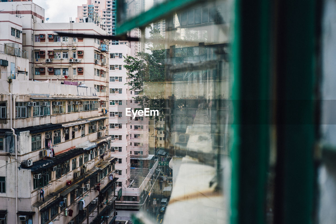 Buildings in city see through window