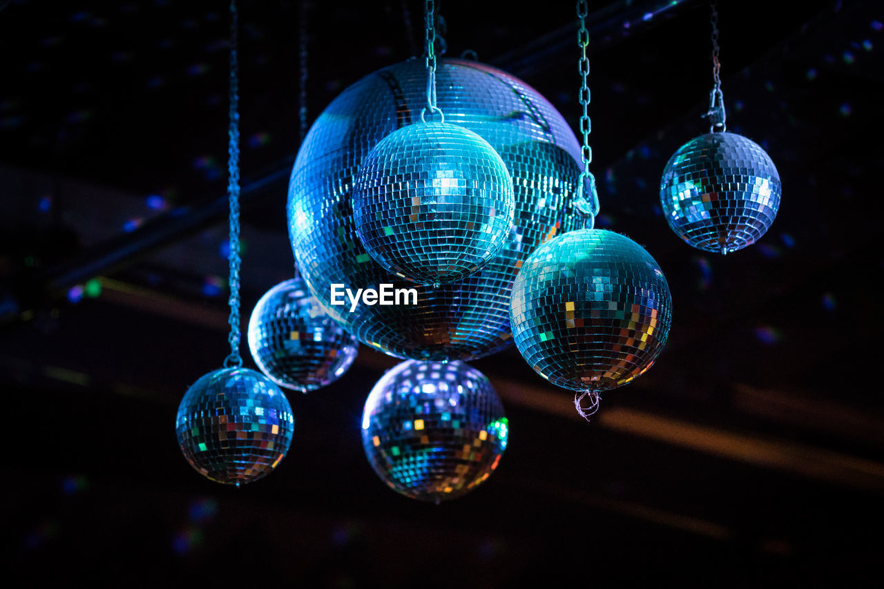 Low angle view of disco balls hanging at nightclub