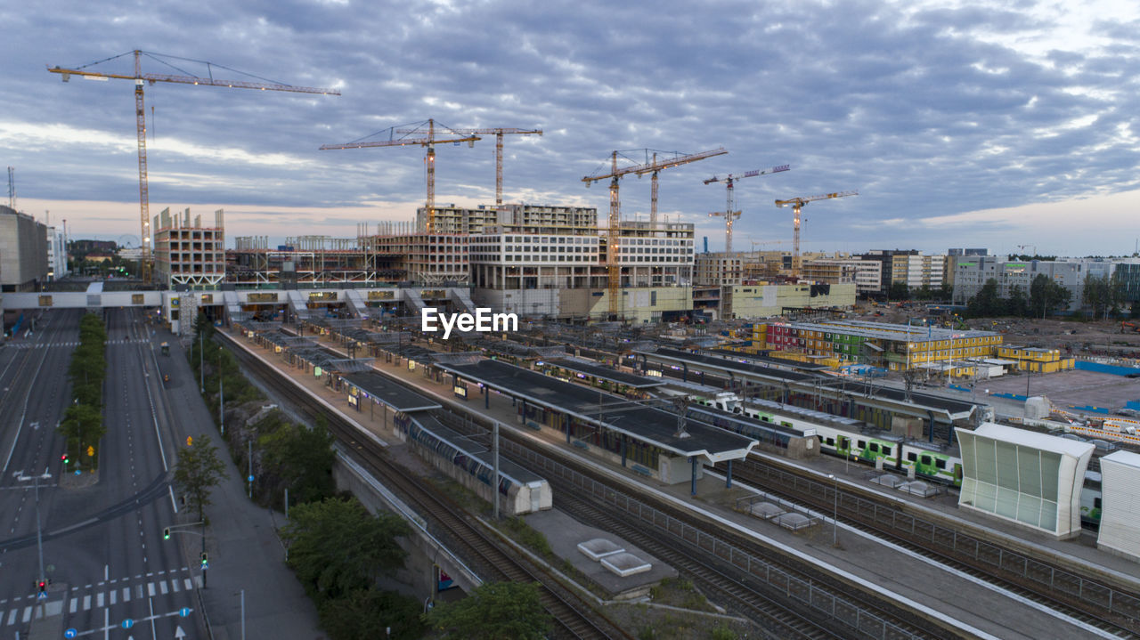 Aerial view of train in city against cloudy sky