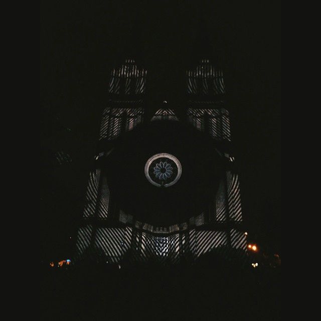 LOW ANGLE VIEW OF ILLUMINATED BUILT STRUCTURE AT NIGHT