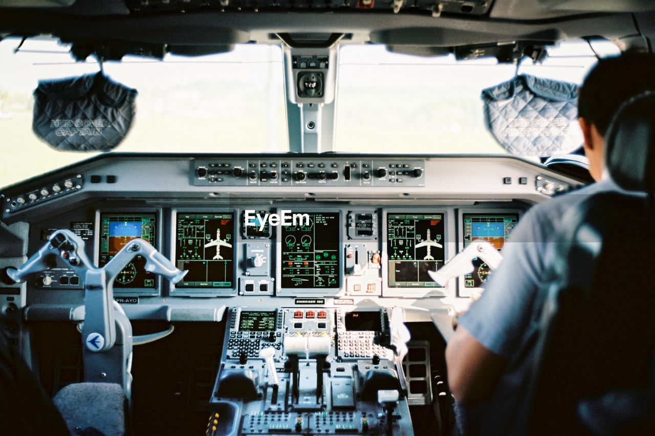 Rear view of pilot sitting in cockpit