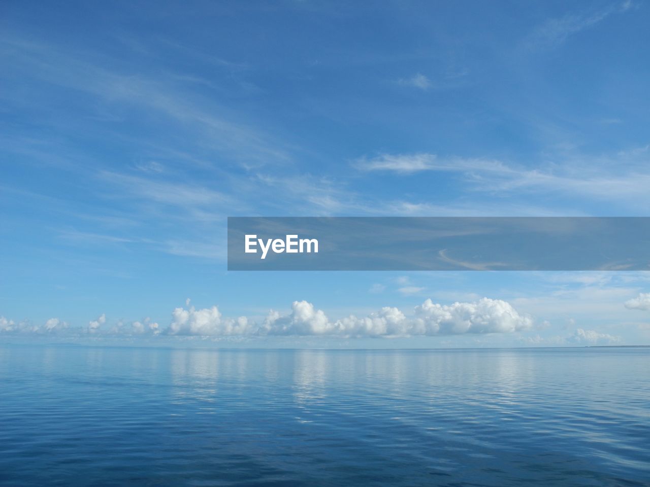 Scenic view of sea against blue sky