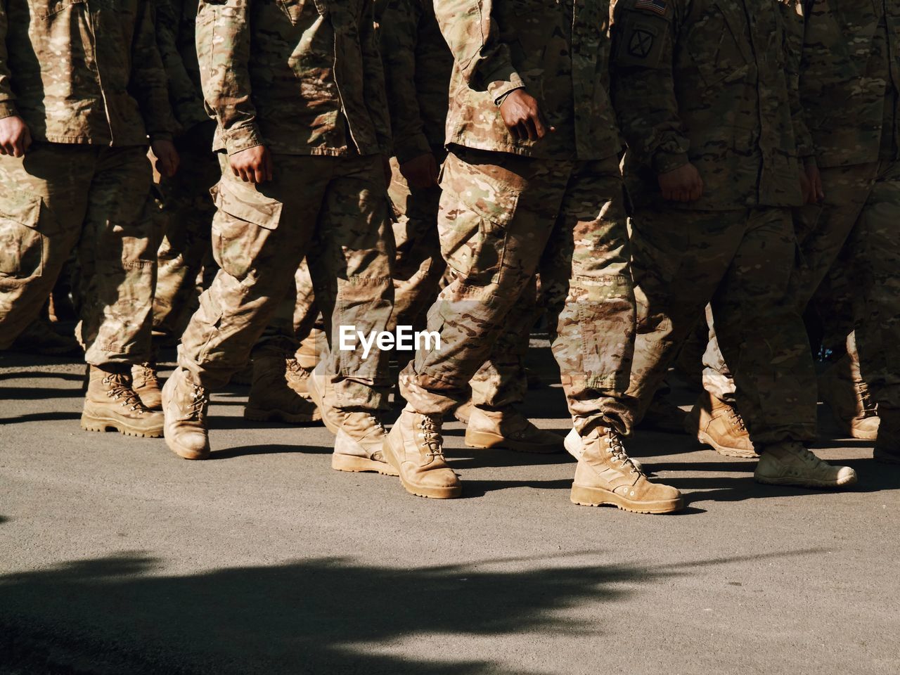 Low section of army soldiers walking on street