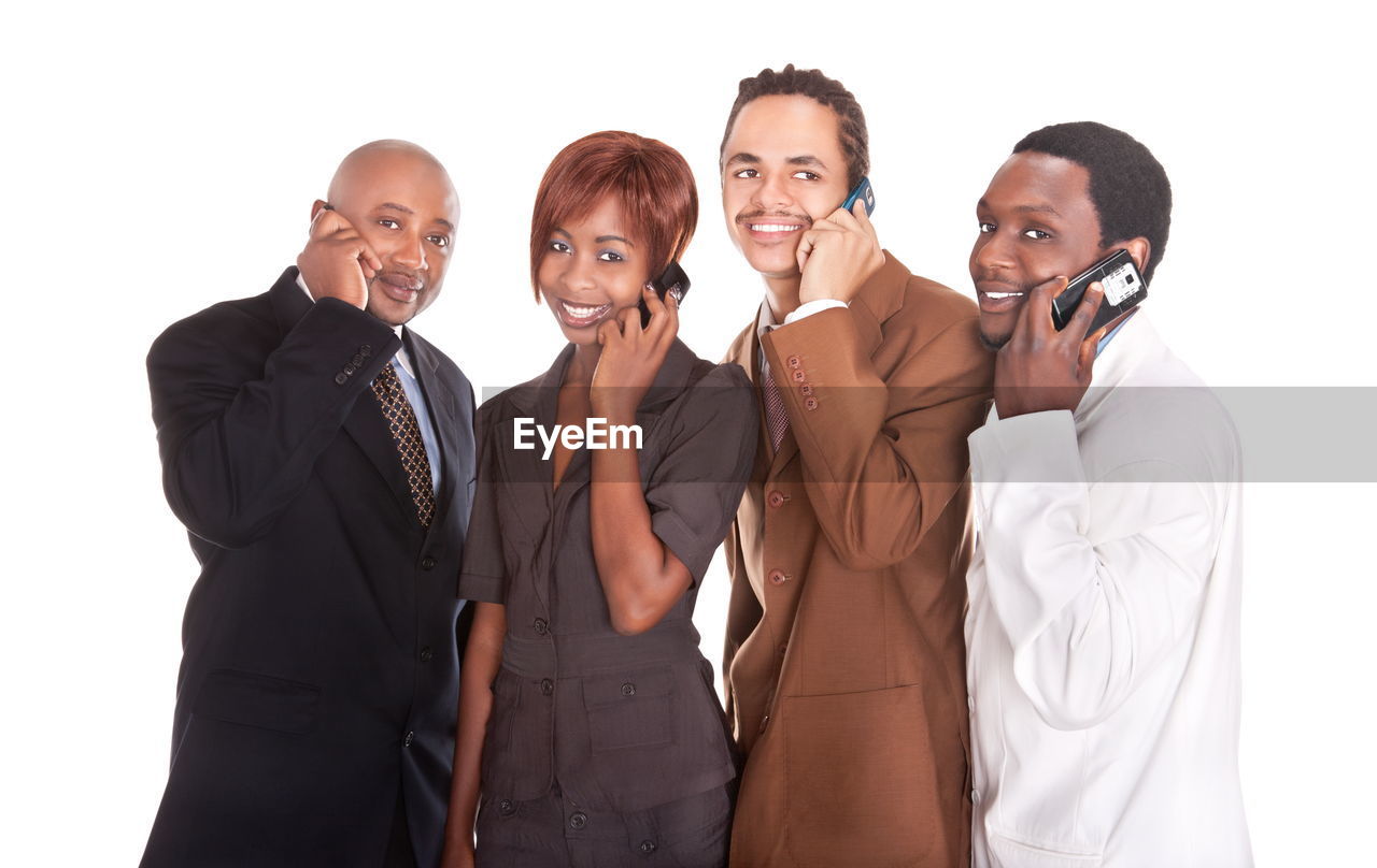 group of people, men, adult, business, women, businessman, communication, businesswoman, white background, female, smiling, cut out, formal wear, young adult, indoors, studio shot, emotion, happiness, portrait, standing, togetherness, person, technology, coworker, clothing, occupation, wireless technology, white-collar worker, corporate business, looking at camera, telephone, talking, cooperation, business finance and industry, mature adult