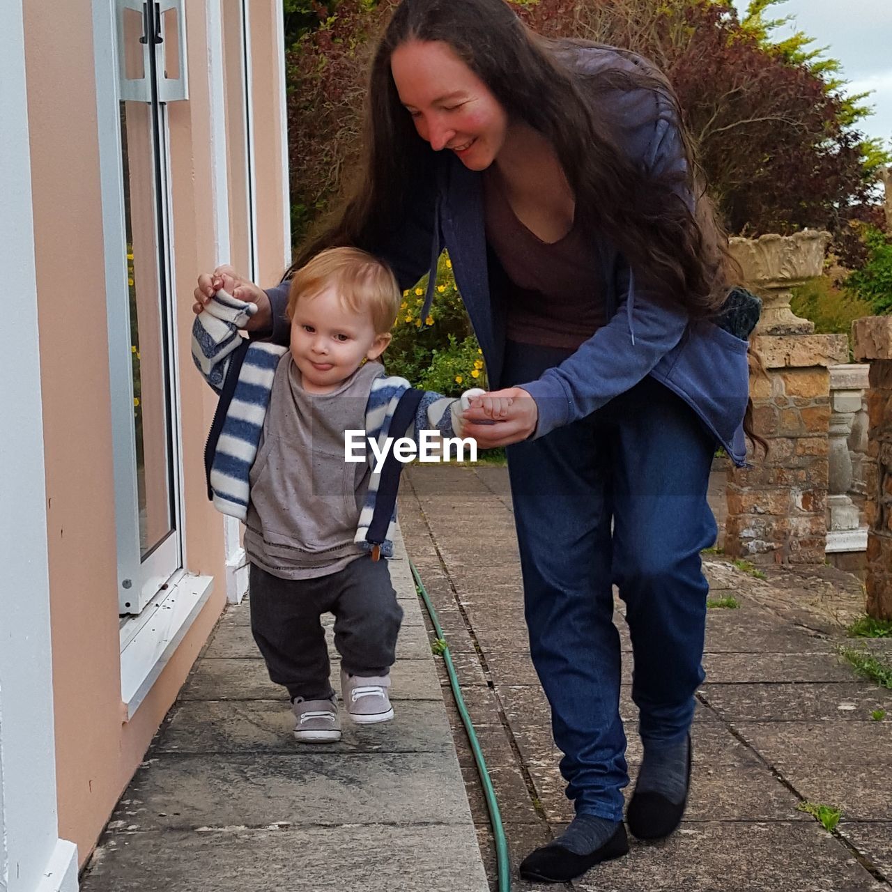 Mother and son learning to walk