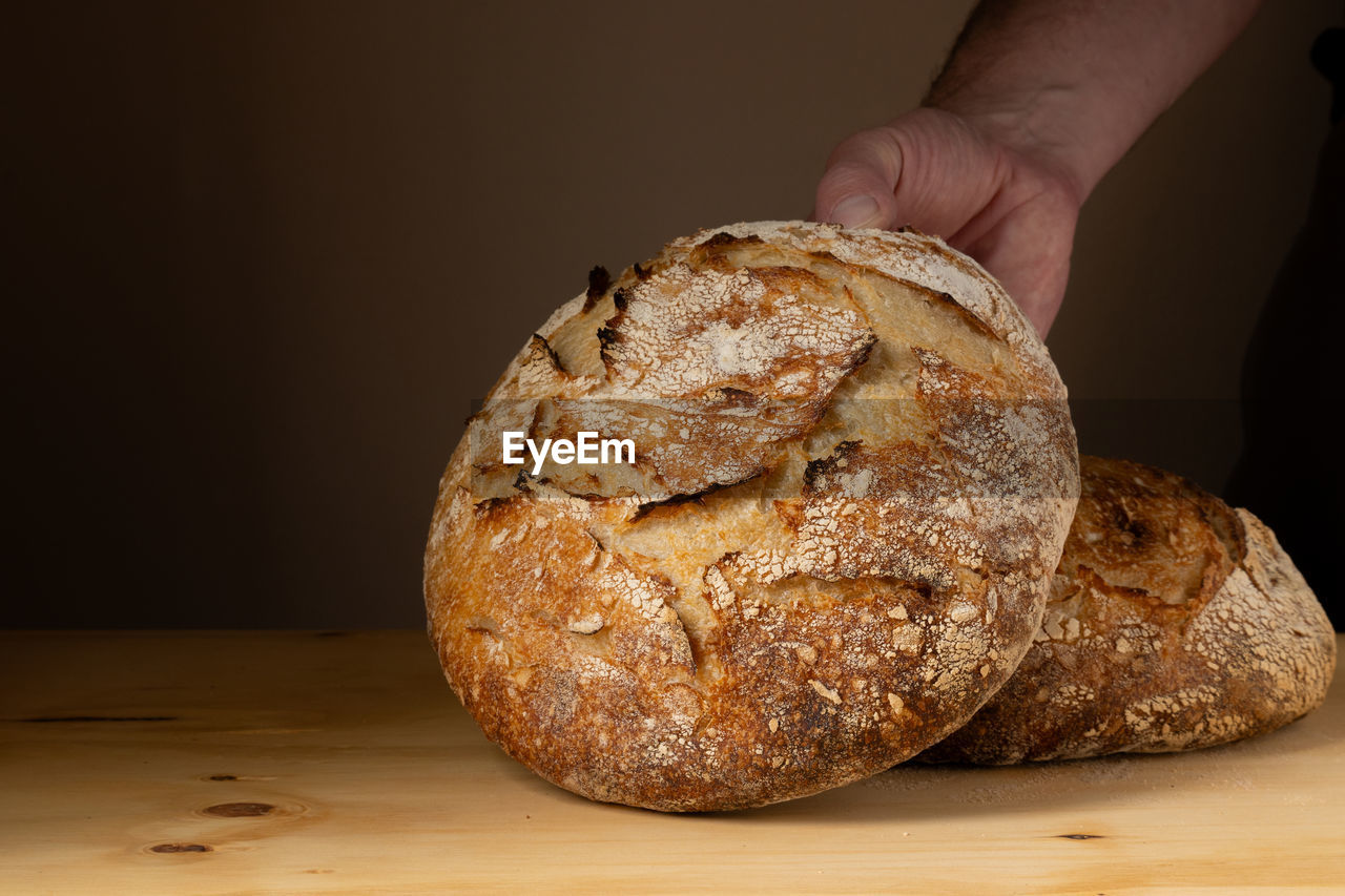 cropped image of hand holding bread