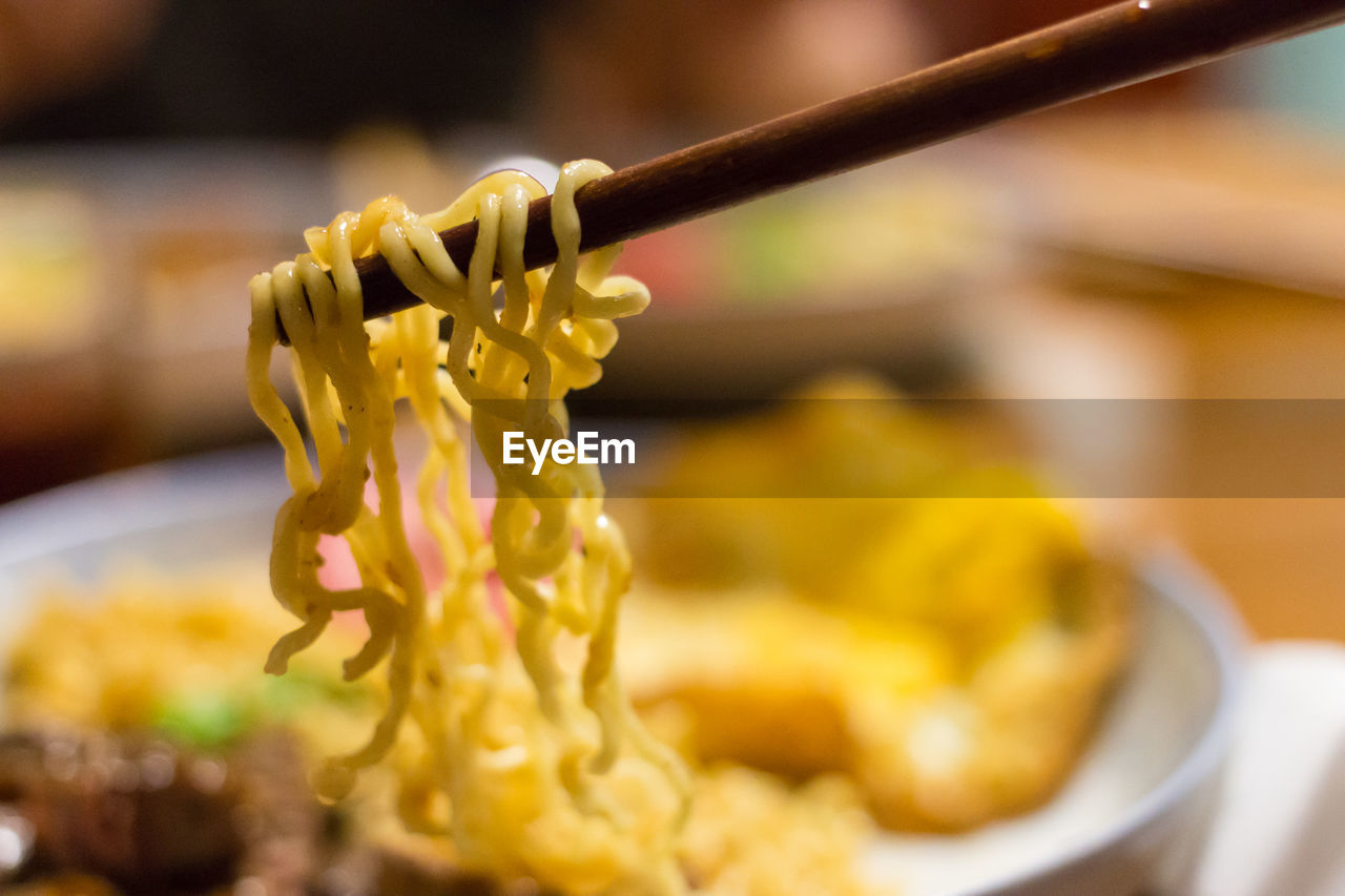 Close-up of noodles on chopstick