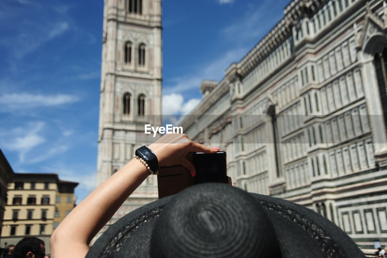 Low angle view of woman photographing italy