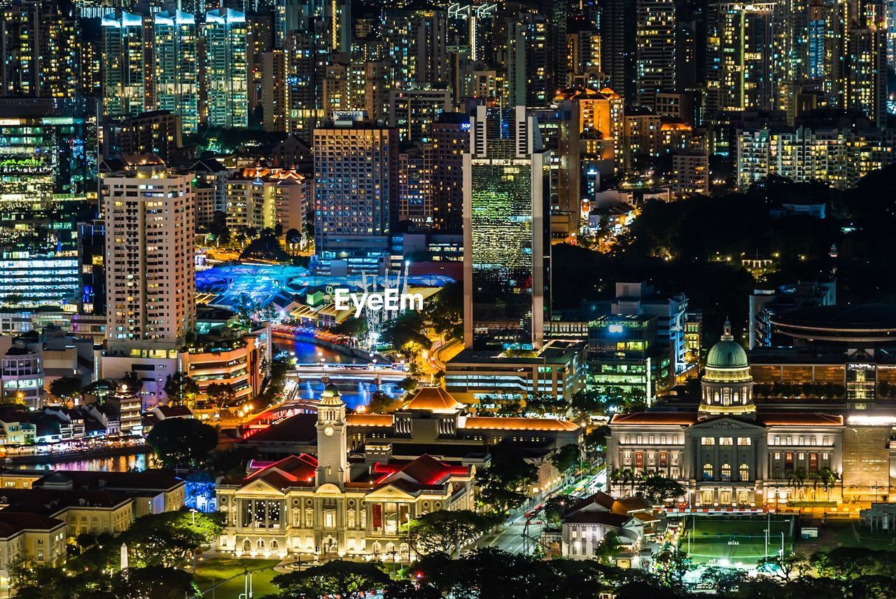 HIGH ANGLE VIEW OF ILLUMINATED MODERN BUILDINGS IN CITY