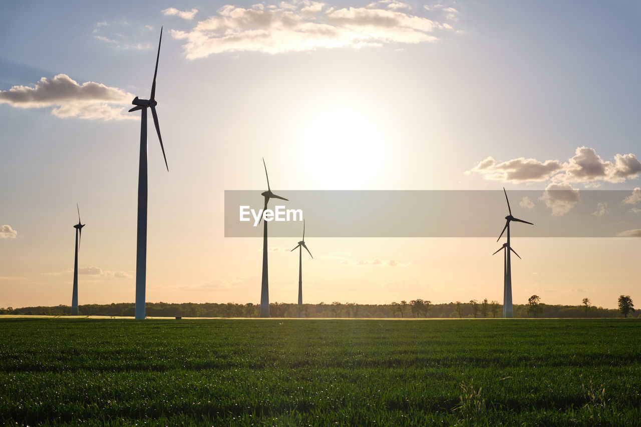 Landscape with modern wind turbines just before sunset seen in germany