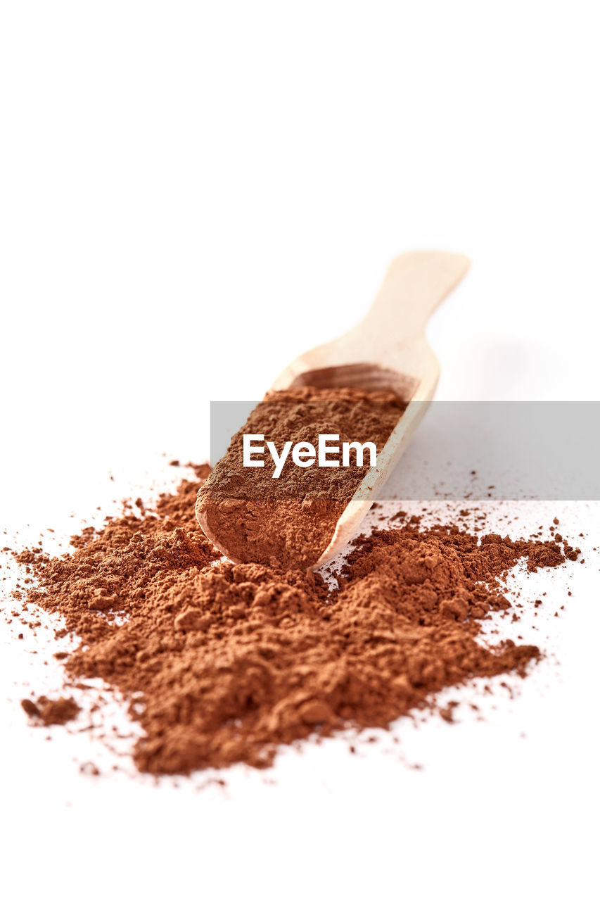 Close-up of cocoa powder against white background