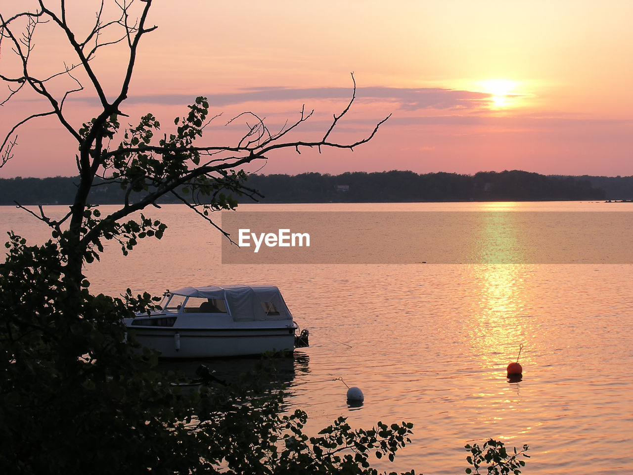 Scenic view of lake against sky during sunset