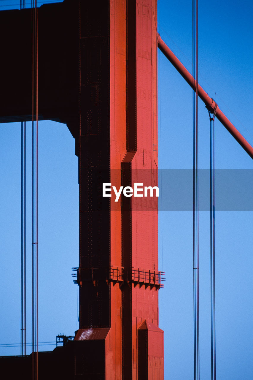 Close-up of the golden gate bridge against a clear blue sky