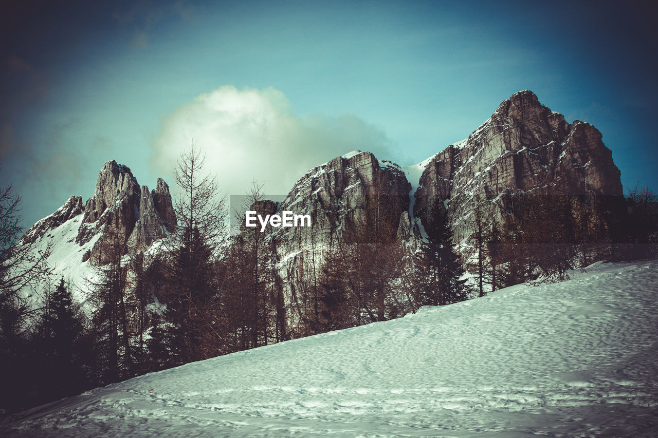 Vintage effect of breathtaking winter panorama of dolomite walls at sunset