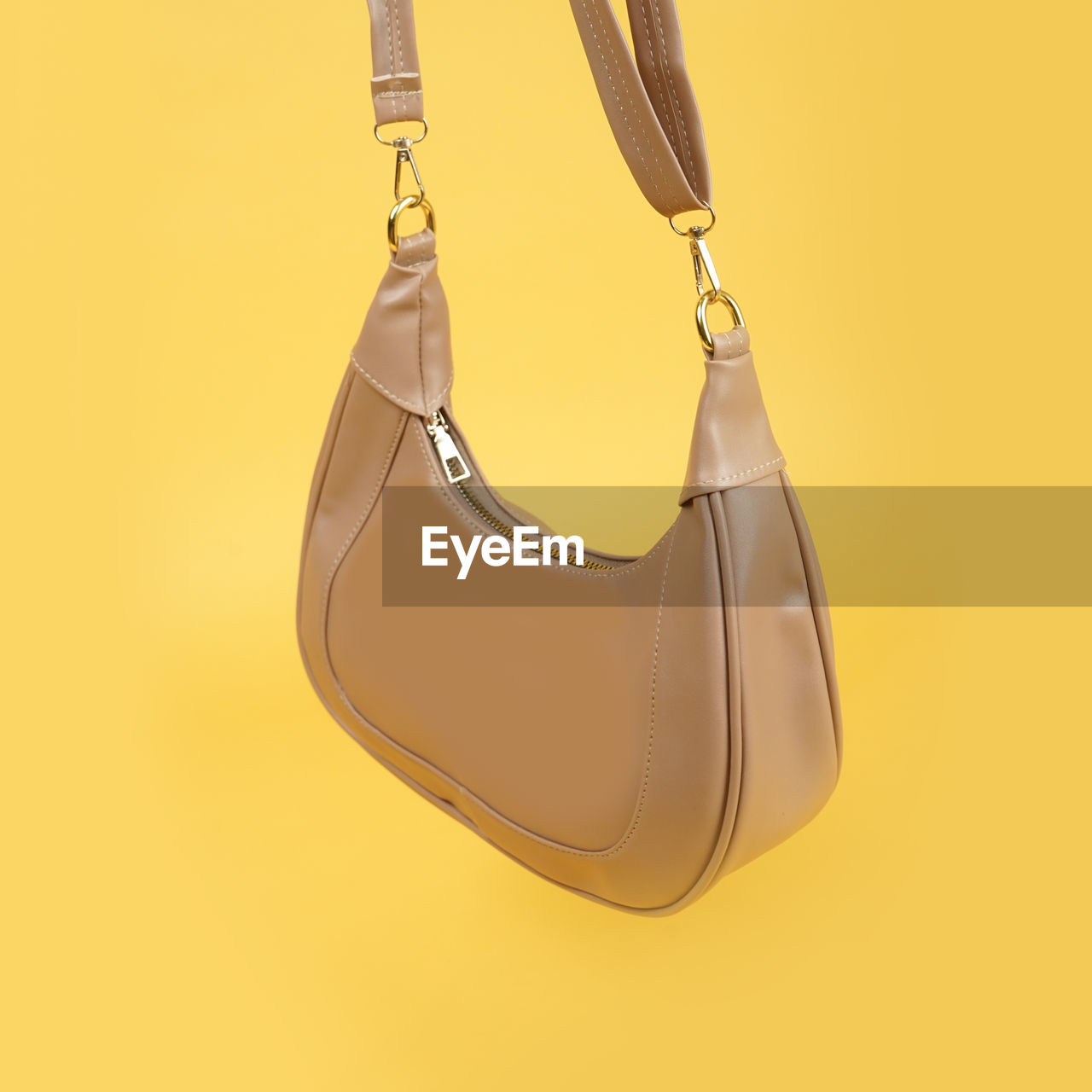 yellow, handbag, studio shot, colored background, hanging, fashion, yellow background, indoors, no people, gold, bag, shoe, fashion accessory, hobo bag, shiny, elegance, wealth
