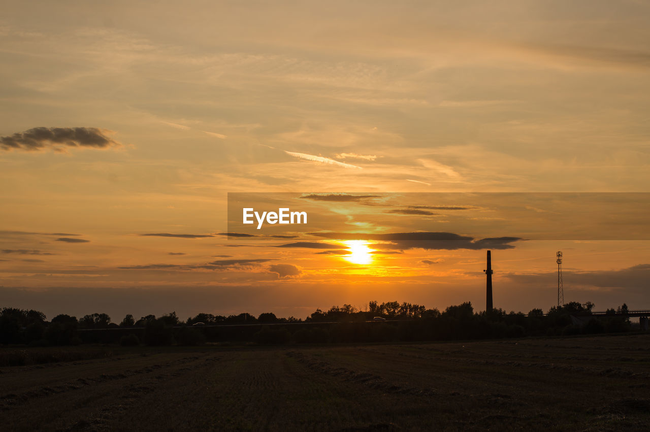 Scenic view of field against sky during sunset