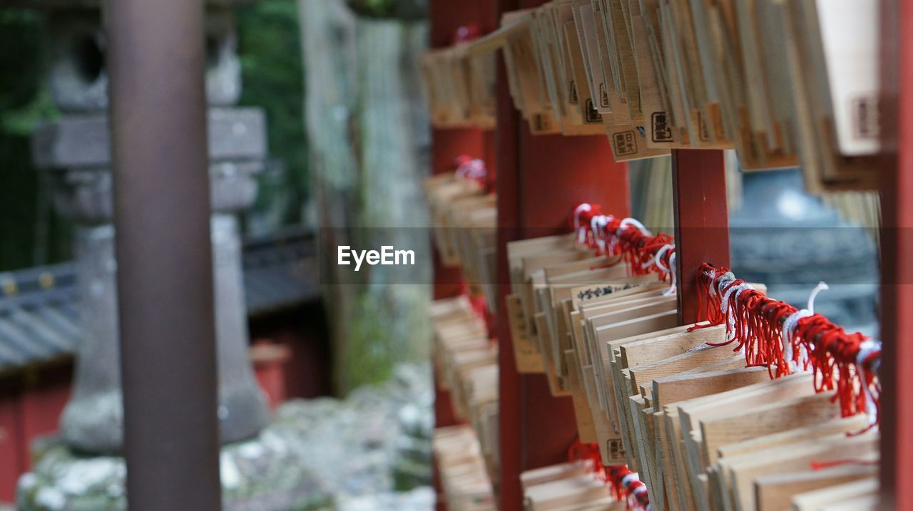 Close-up of wishes tied to pole