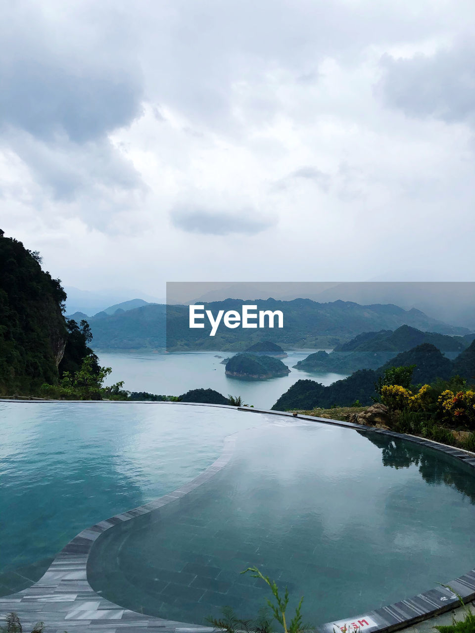 SCENIC VIEW OF LAKE BY MOUNTAIN AGAINST SKY