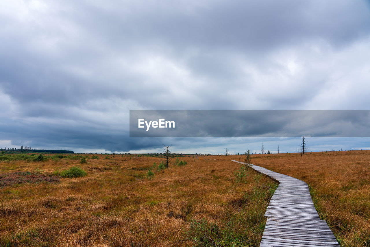 FOOTPATH ON FIELD AGAINST SKY