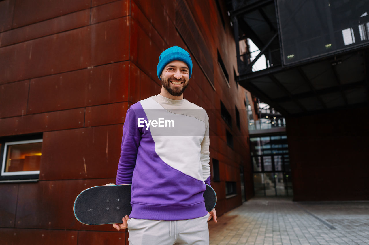 Portrait of a skater. a skateboarder at an urban location looks into the camera