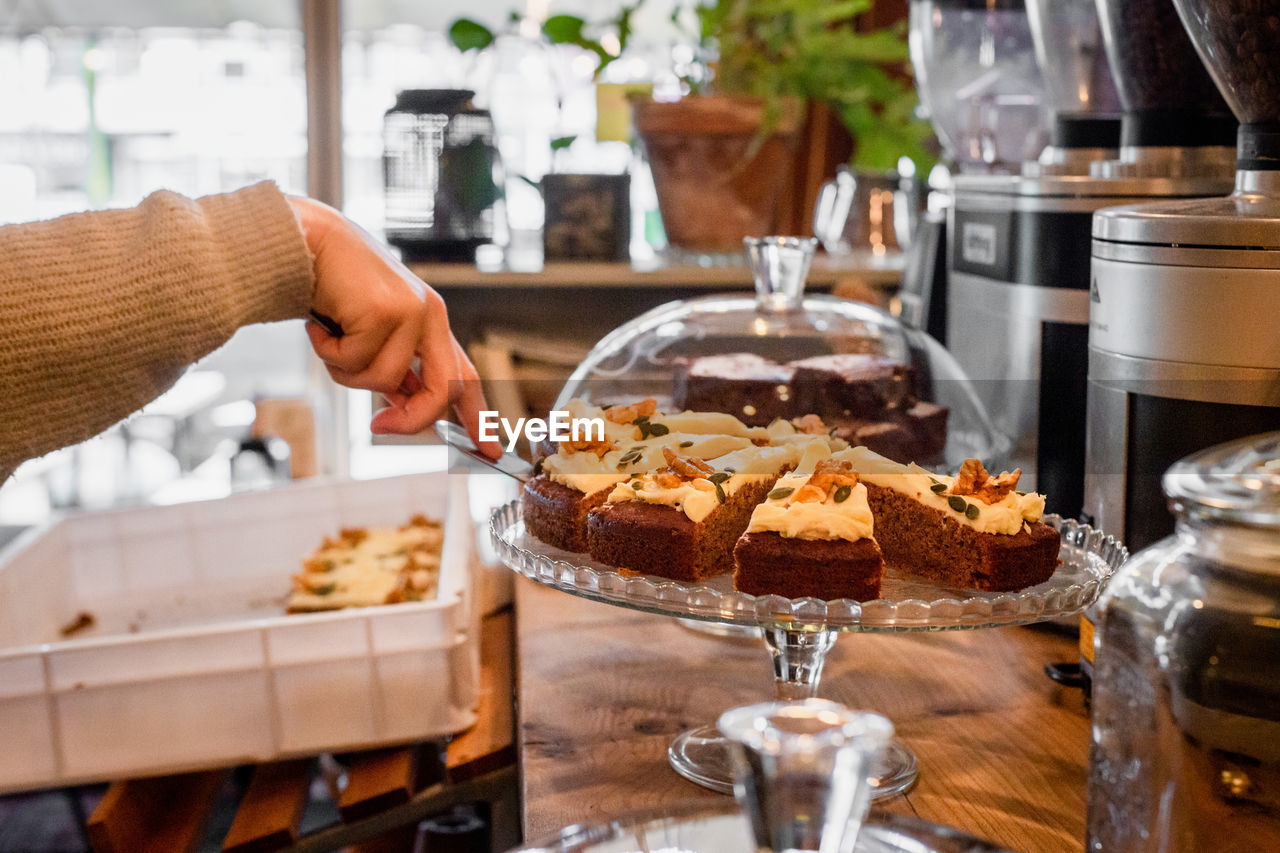 Cropped image of hand holding cake