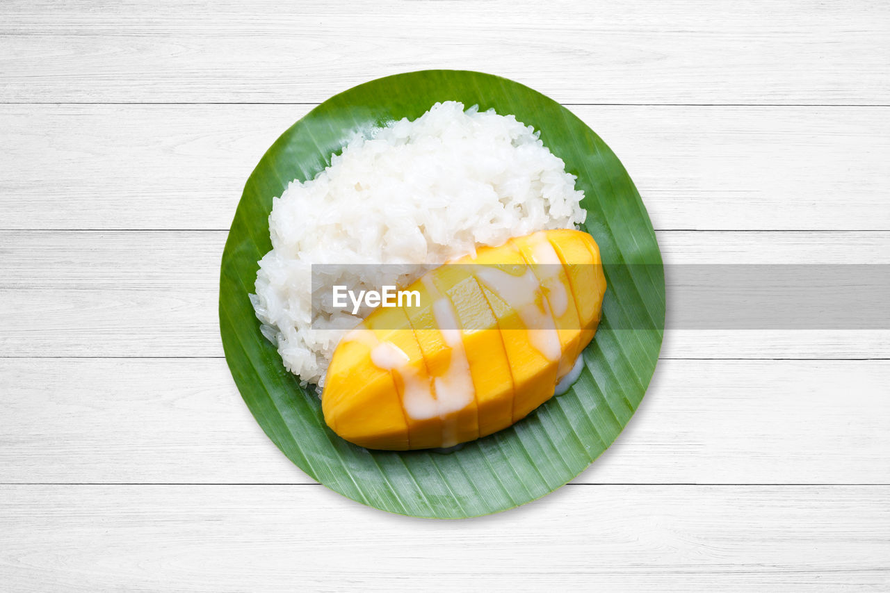 High angle view of sticky rice and mango served on table