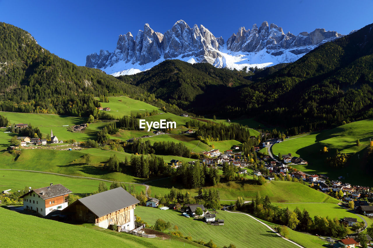 Scenic view of green landscape and mountains against sky