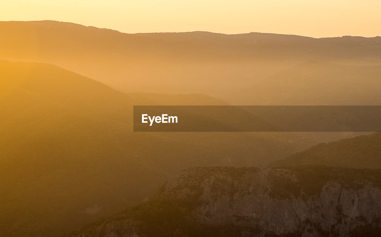 SCENIC VIEW OF LANDSCAPE AGAINST SKY DURING SUNSET